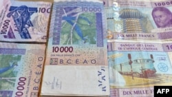 FILE - CFA franc banknotes by the Central Bank of West African States are seen in N'djamena, Chad, April 9, 2016. Some experts argue that the colonial era currency has outlived its usefulness. 