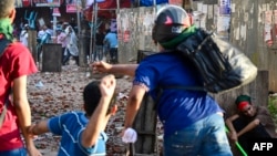 Protesters of Bangladesh's quota system for government jobs clash with students who back the ruling Awami League party in Dhaka on July 16, 2024.