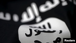FILE- An Islamic State flag is seen in this photo illustration.
