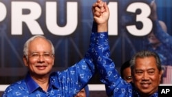 PM Malaysia Najib Razak (kiri) dan wakilnya Muhyiddin Yassin merayakan kemenangannya setelah memenangkan pemilu di Kuala Lumpur, Malaysia, 6 Mei 2013 (Foto: dok).