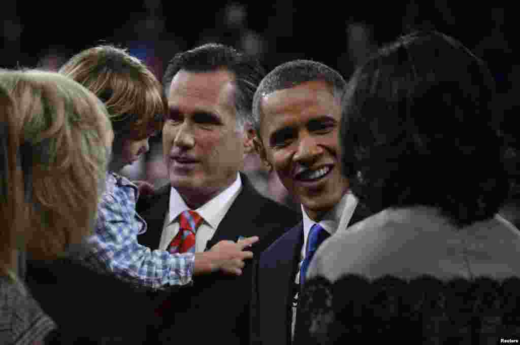 U.S. President Barack Obama and Republican presidential nominee Mitt Romney greet family members following the final U.S. presidential debate in Boca Raton, Florida October 22, 2012.