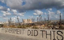 FILE - Words are written by Lebanese citizens in front of the scene of the Aug. 4 explosion that hit the seaport of Beirut, Lebanon, Aug. 9, 2020.