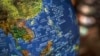FILE - A globe shows the islands on the South China Sea with nine-dash line claims under Chinese territory on display at a bookstore in Beijing, July 13, 2018. 