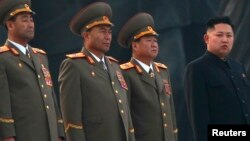 North Korean leader Kim Jong-un (R) stands with military officers in Pyongyang April 13, 2012. 