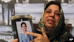 Pakistani mother, Sarwari Begum, shows a picture of her daughter, Bushra Khalique, 27, who is reportedly missing after a crush during the Hajj pilgrimage in Saudi Arabia, Sept. 26, 2015 in Karachi, Pakistan. 