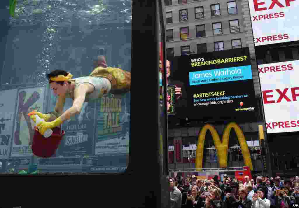 Artist Annie Saunders performs "Cleaning" in Times Square in New York.