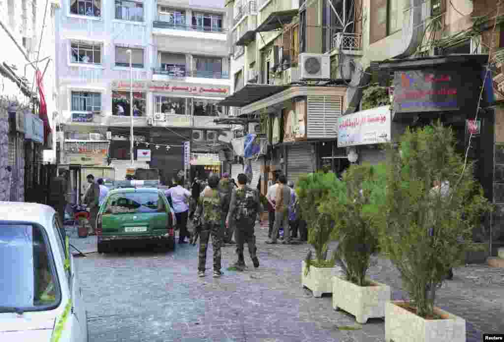 This SANA photo shows the destruction after bombs exploded in al-Marjeh Square in Damascus, June 11, 2013.