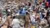 South Sudanese pick through a sea of trash outside Juba, looking for plastic bottles that they can exchange for money at a local NGO. 