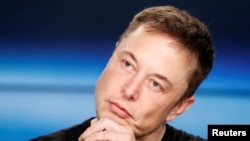 FILE - Elon Musk listens at a press conference following the first launch of a SpaceX Falcon Heavy rocket at the Kennedy Space Center in Cape Canaveral, Florida, U.S., Feb. 6, 2018. 
