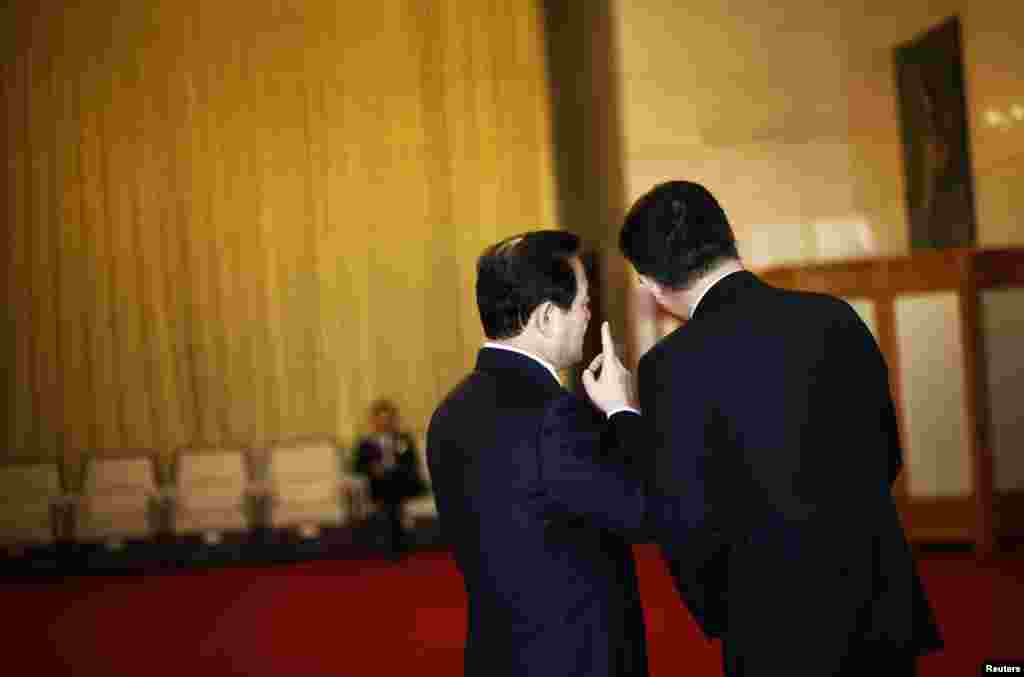 Delegates chat outside of the Guangxi room before a meeting at the Great Hall of the People, the venue of the 18th National Congress of the Communist Party of China in Beijing, November 8, 2012.