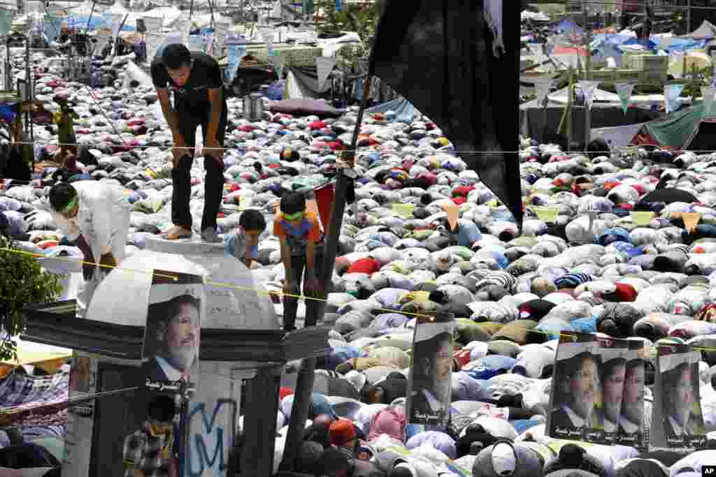 Supporters of Egypt's ousted President Mohammed Morsi offer their Friday prayer where protesters have installed their camp and held their daily rally, at Nasr City, Cairo, Egypt, July 19, 2013. 