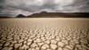 Awan tebal menyelimuti Graaff-Reinet, Afrika Selatan, namun tidak menghasilkan hujan, sementara retakan terlihat pada bendungan yang mengering akibat kekeringan, 14 November 2019. (Foto: Reuters)
