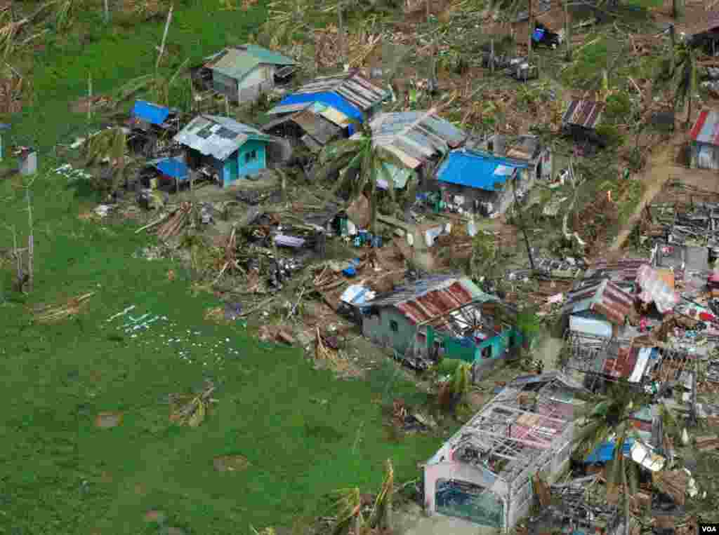 A devastated village in Eastern Samar province makes a plea for help, Philippines, Nov. 19, 2013. (Steve Herman/VOA)