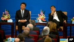Chinese President Xi Jinping and Ecuador's President Rafael Correa, right attend the opening ceremony to a two-day meeting between China and Latin American and Caribbean countries held at the Great Hall of the People in Beijing, China, Jan. 8, 2015.