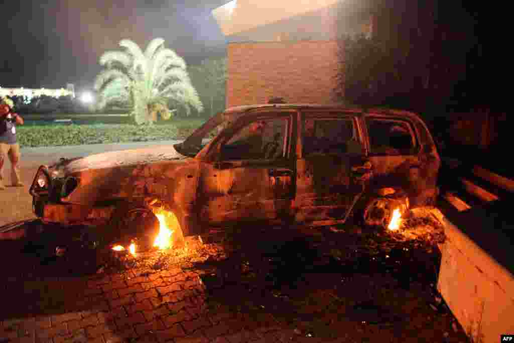 A vehicle sits smoldering in flames after being set on fire inside the US consulate compound in Benghazi late on September 11, 2012.