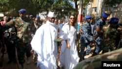 FILE - Gambian President Yahya Jammeh arrives at a polling station with his wife Zineb during the presidential election in Banjul, Gambia, Dec. 1, 2016.