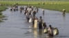 FILE - Rohingya refugees who have fled Myanmar’s Rakhine state, cross into Bangladesh at Palong Khali in the Cox’s Bazar district in this photo taken in mid-October 2017.