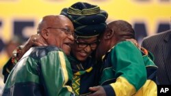 Winnie Madikizela-Mandela, centre, hugs front runner and Deputy President, Cyril Ramaphosa, right, and President Jacob Zuma, left, at the start of the ruling African National Congress (ANC) elective conference in Johannesburg, South Africa, Dec. 16 2017. 