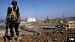 A Yemeni soldier is seen standing guard at the natural gas plant in Balhaf in this November 7, 2009, file photo.