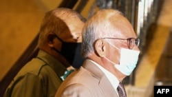 FILE - Malaysia former prime minister Najib Razak, right, arrives at the court of appeal in Putrajaya on April 5, 2021. 