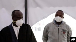 FILE -Kenyan police officer Duncan Ndiema Ndiwah, right, appears to face murder charges at the High Court June 23, 2020.
