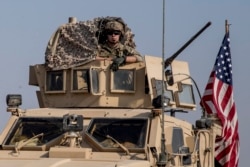 U.S. military convoy drives near the town of Qamishli, northen Syria, Oct. 26. 2019.