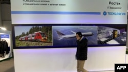 An Iranian man walks past a display of the Russian company Poctex on Dec. 22, 2015, during the Russia National Industrial Exhibition in Tehran. Russia is said to be boosting investment in Iran following the announcement of the construction of two nuclear reactors. 