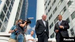 FILE - Palestinian Foreign Minister Riad al-Malki (C) leaves the International Criminal Court (ICC) at the Hague, Aug. 5, 2014.