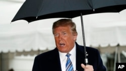 President Donald Trump speaks about the coronavirus as he walks to Marine One to depart from the White House, March 28, 2020, in Washington. 