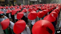 Anti-coup school teachers in their uniform and traditional Myanmar-hats participate in a demonstration in Mandalay, Myanmar, Wednesday, March 3, 2021. Demonstrators in Myanmar took to the streets again on Wednesday to protest last month's seizure of…