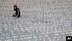 La OMS señala que en Europa siguen aumentando los casos COVID. En esta imagen de archivo del 10 de mayo de 2021, una mujer enciende una vela para recordar a las víctimas de la pandemia en el Castillo de Praga, en Praga, República Checa. (AP Foto/Petr David Josek, archivo)