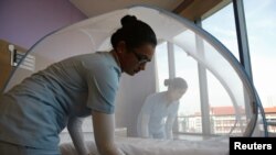 Nurses set up a mosquito tent over a hospital bed, as part of a precautionary protocol for patients who are infected by Zika at Farrer Park Hospital in Singapore Sept. 2, 2016.