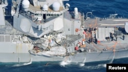 The Arleigh Burke-class guided-missile destroyer USS Fitzgerald, damaged by colliding with a Philippine-flagged merchant vessel, is seen off Shimoda, Japan, June 17, 2017, in this photo taken by Kyodo.