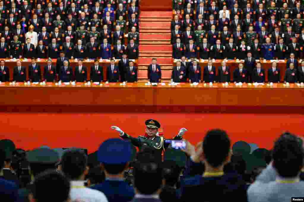 在北京人民大会堂举行的中国共产党第十九次全国代表大会闭幕式上,乐队指挥指挥军乐队演奏国歌,全体代表起立(2017年10月24日)。