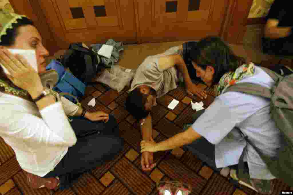 An injured protester is helped in the basement of a hotel where protesters took shelter next to Gezi Park near Istanbul's Taksim Square, June 15, 2013.