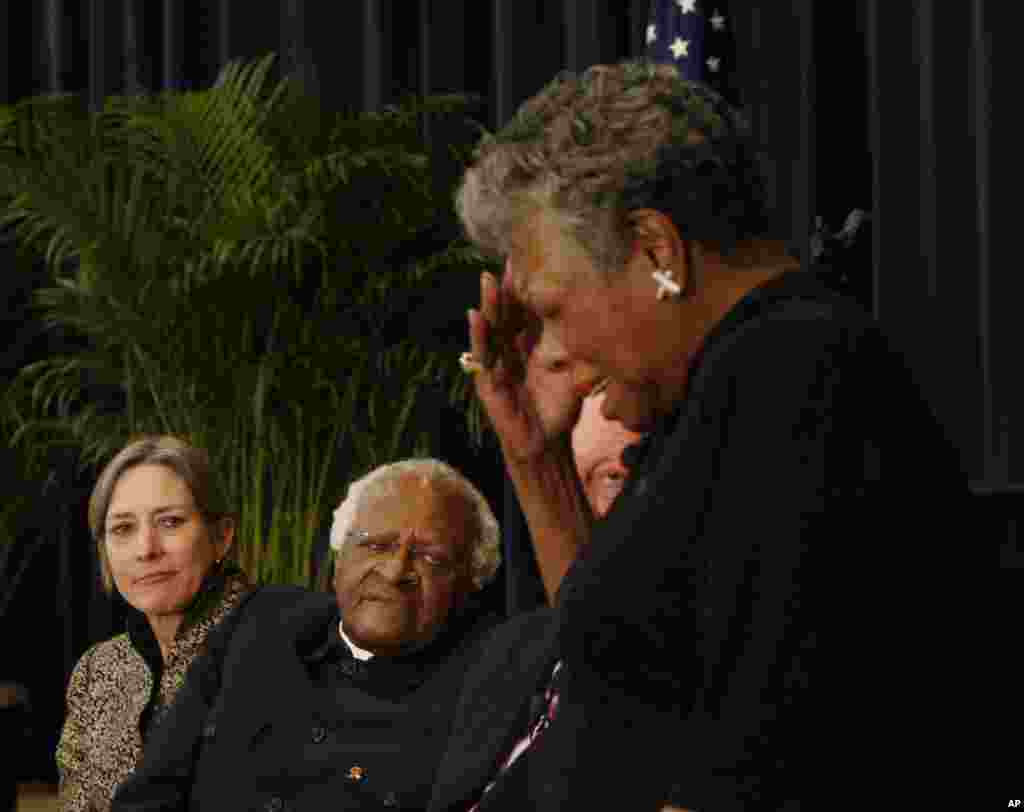 South African Archbishop Emeritus Desmond Tutu listens as author Maya Angelou delivers a tribute to him at the J. William Fulbright Prize for International Understanding Award Ceremony in Washington, Nov. 21, 2008.