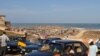 Taxis drivers wait for passengers near an beachfront slum in Accra's Jamestown (VOA/Laura Burke, Sept 2012).