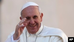 Pope Francis waves as he arrives to lead his Wednesday general audience in Saint Peter's Square at the Vatican, Sept. 18, 2013.