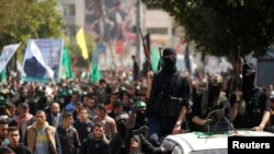 Palestinian members of Hamas' armed wing take part in the funeral of senior militant Mazen Fuqaha in Gaza City, March 25, 2017. 