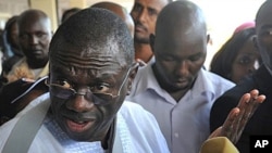 Uganda's opposition leader Kizza Besigye talks to the media at Jommo Kenyatta International Airport, in Nairobi, May 11, 2011