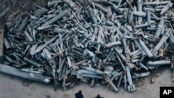 Police officers look at collected fragments of the Russian rockets that hit Kharkiv, in Kharkiv, Ukraine, Saturday, Dec. 3, 2022. (AP Photo/Libkos)