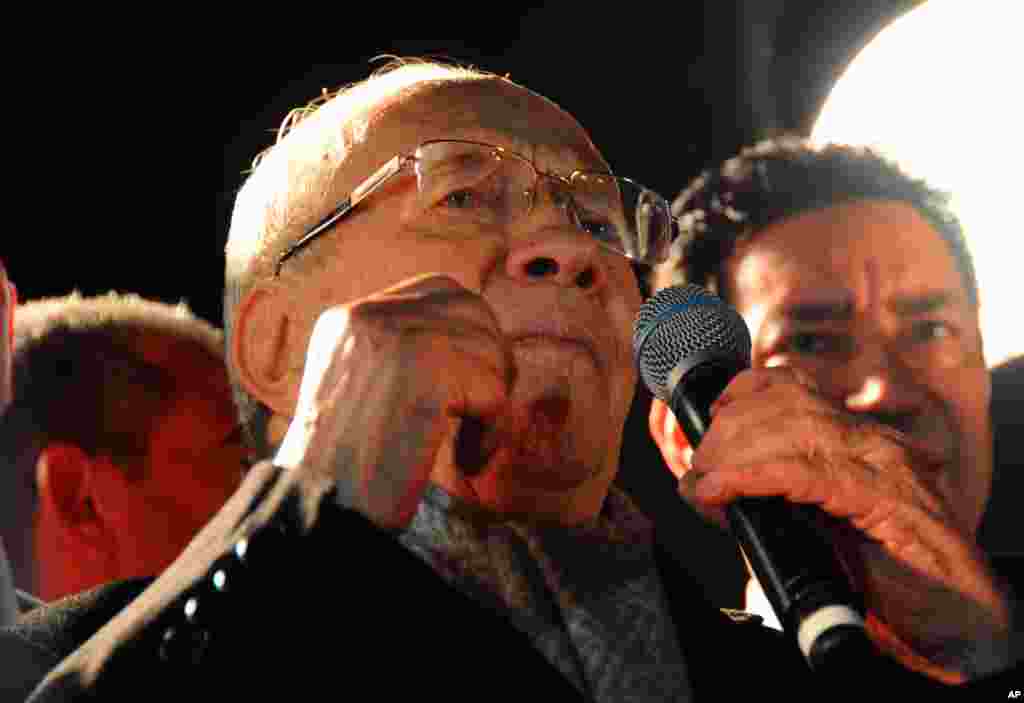 Tunisian presidential candidate Beji Caid Essebsi gives a speech in front his supporters after the second round of the country's presidential election, in Tunis, Sunday, Dec. 21, 2014.