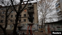 FILE PHOTO: View shows an apartment building damaged by a recent Russian military strike in Kherson