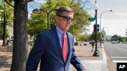 FILE - In this Sept. 10, 2019 file photo, Michael Flynn, President Donald Trump's former national security adviser, leaves the federal court following a status conference in Washington. 