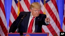 FILE - President-elect Donald Trump takes questions during a news conference in New York, Jan. 11, 2017. The news conference was his first as president-elect.