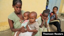 File - A 34-year-old displaced single mother, is seen with her five children in Nebelet, Tigray region, Ethiopia, as food aid runs out there, July 21, 2021.