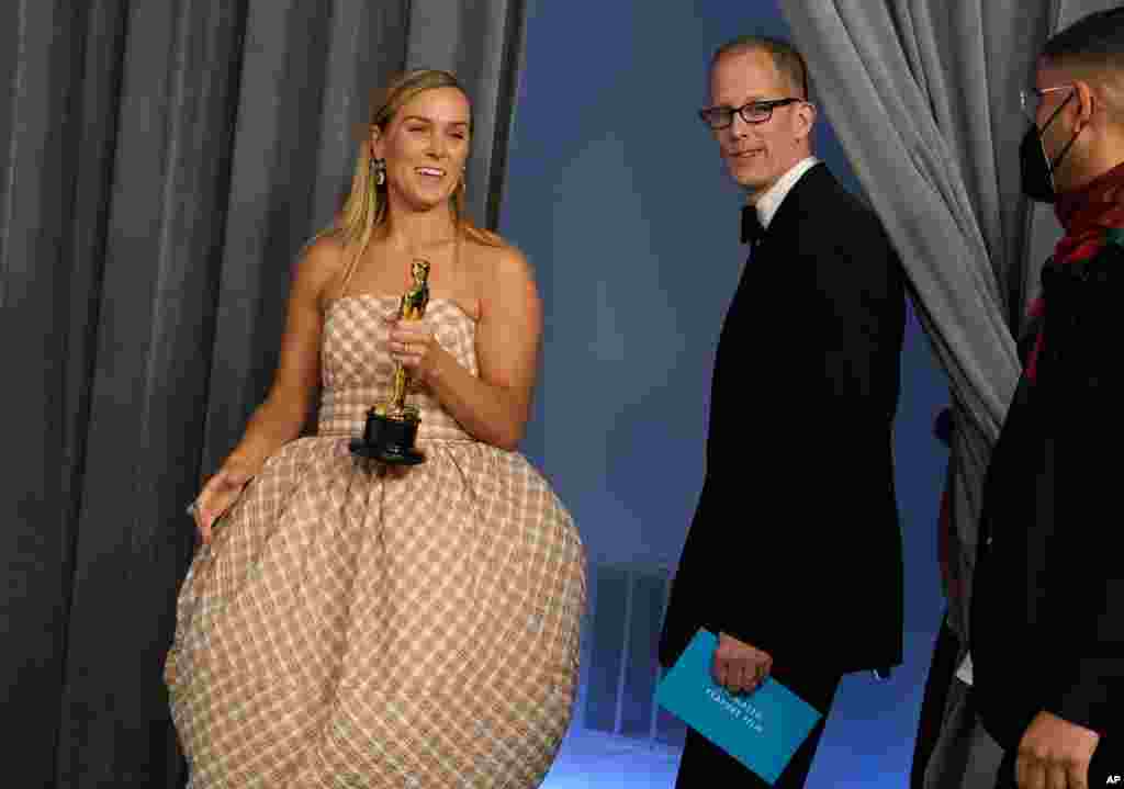 Dana Murray, left, and Pete Docter, winners of the award for animated feature film for "Soul," enter in the press room at the Oscars on Sunday, April 25, 2021, at Union Station in Los Angeles. (AP Photo/Chris Pizzello, Pool)
