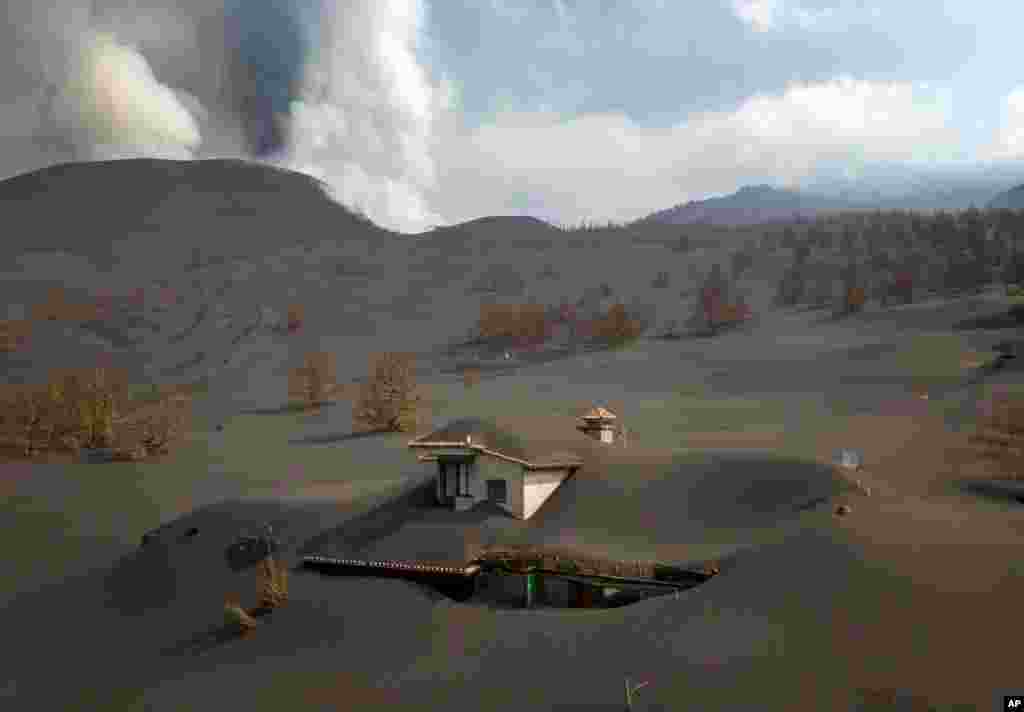 A house is covered by ash from a volcano as it continues to erupt on the Canary island of La Palma, Spain, Oct. 30, 2021.