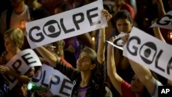 A demonstrator holds a sign that reads in Portuguese "Coup" during a protest against the impeachment of Brazil's President Dilma Rousseff, in Rio de Janeiro, Brazil, May 10, 2016.