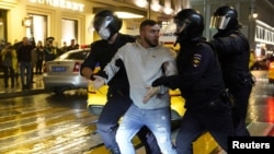 Police officers detain a participant in a protest against amendments to Russia's constitution and the results of a nationwide vote on constitutional reforms, in Moscow, July 15, 2020.